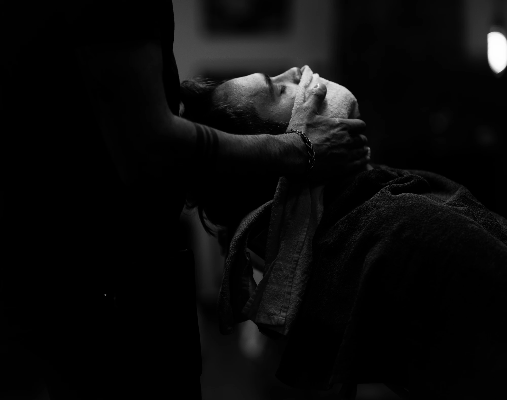 Head with towel on face, low light