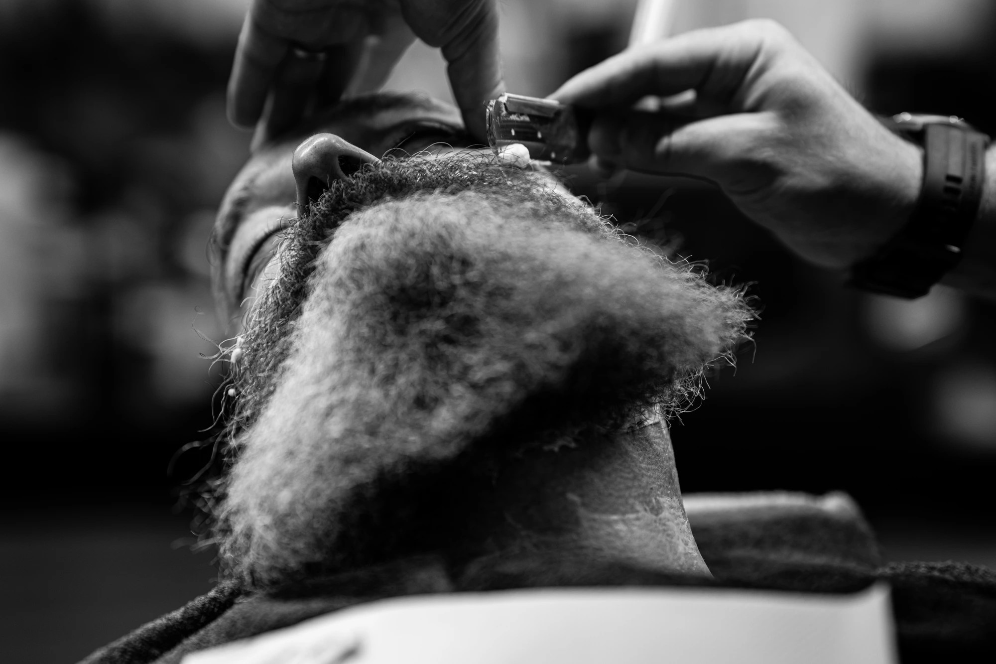 Knife razor trimming a thick gray beard