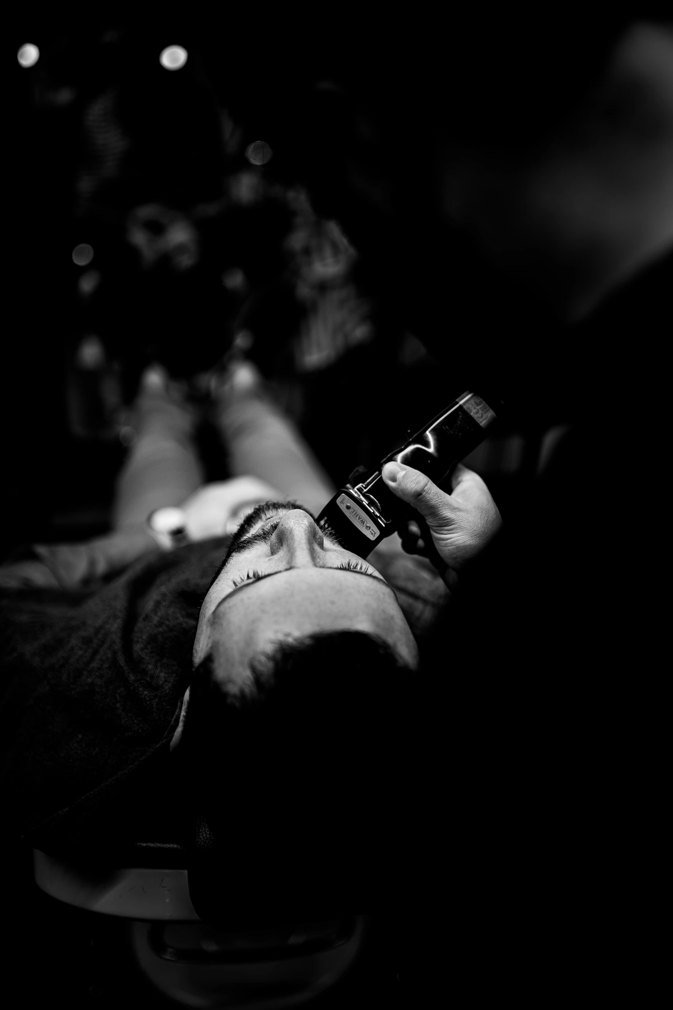 Hair clipper with bokeh lights in dark environments